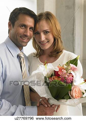 Couple with a bouquet View Large Photo Image Stock Photograph - Couple with a bouquet. Fotosearch