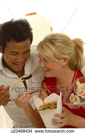 Picture - Couple with Asian food. Fotosearch