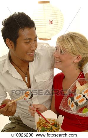 Stock Image - Couple with Asian food. Fotosearch