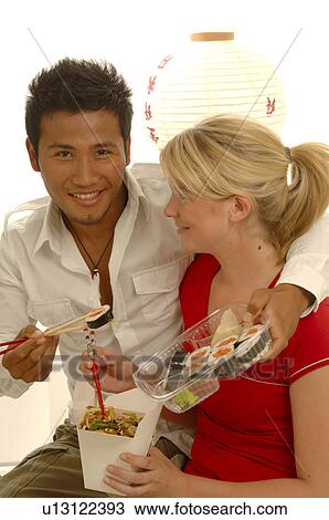 Stock Image - Couple with Asian food. Fotosearch