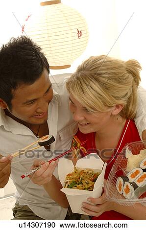Stock Image - Couple with Asian food. Fotosearch