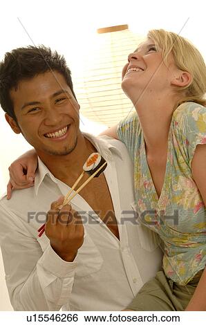Stock Photograph - Couple with Asian food. Fotosearch
