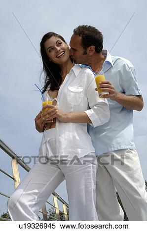 Couple with drinks - man is kissing woman on her neck View Large Photo Image Stock Photography - Couple with drinks - man is kissing woman on her neck. Fotosearch