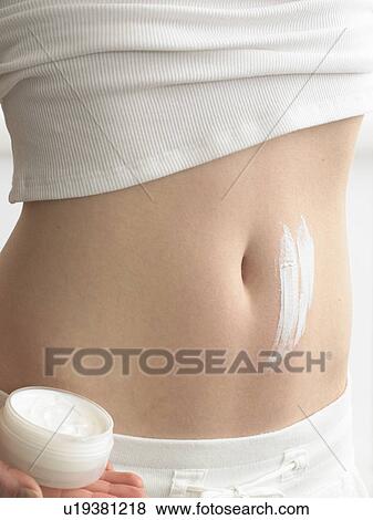 Stock Photo - Cream streaks on a belly. Fotosearch