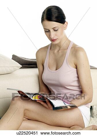 Dark-red haired woman in underwear sitting on the floor reading a magazine View Large Photo Image Stock Image - Dark-red haired woman in underwear sitting on the floor reading a magazine. Fotosearch
