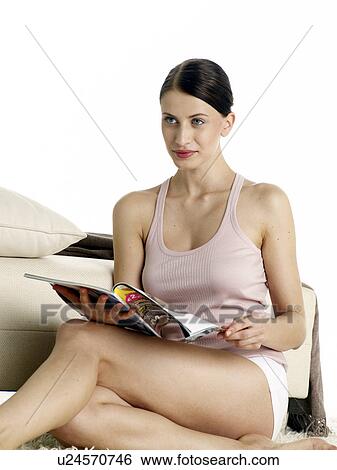 Dark-red haired woman in underwear sitting on the floor reading a magazine View Large Photo Image Stock Photograph - Dark-red haired woman in underwear sitting on the floor reading a magazine. Fotosearch