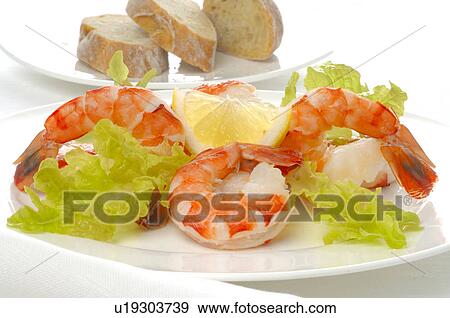 Stock Photo - Dish of shrimps, lemon and salad. Fotosearch