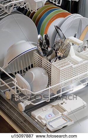 Stock Photo - Dishes and cutlery in dishwasher. Fotosearch