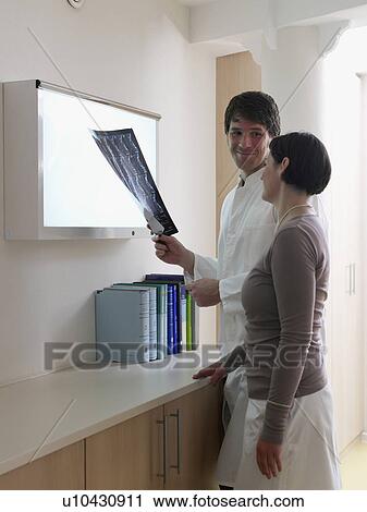 Doctor explaining an x-ray to the patient View Large Photo Image Stock Image - Doctor explaining an x-ray to the patient. Fotosearch