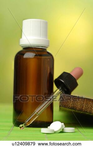Stock Photo - Dr. Schüssler's cell salts pills and a pipette. Fotosearch