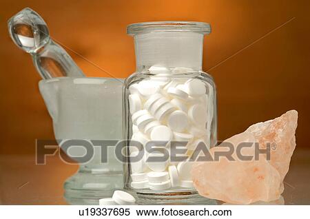 Stock Photography - Dr. Schüssler's cell salts pills in a bottle and rose quartz. Fotosearch