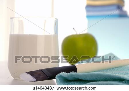 Stock Photo - Facial mask with yoghurt, an apple and a brush. Fotosearch