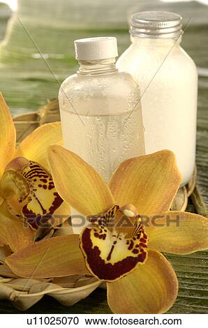 Stock Image - Facial toner with orchid blossom. Fotosearch