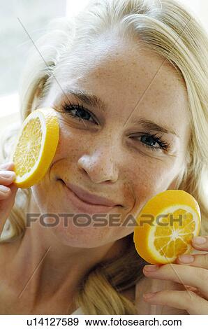 Fair-haired woman with orange slices View Large Photo Image Stock Photo - Fair-haired woman with orange slices. Fotosearch