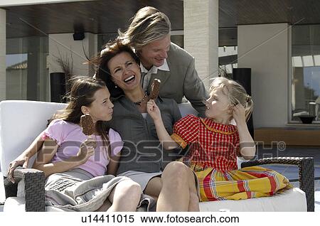 Family sitting on a bench View Large Photo Image Stock Photography - Family sitting on a bench. Fotosearch