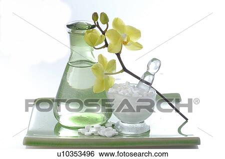 Stock Photograph - Flacon, Schuessler Cell Salts and orchid. Fotosearch
