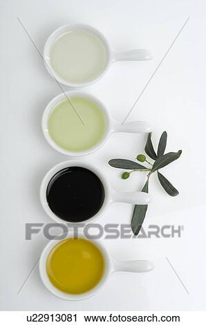 Stock Image - Four bowls with oil and vinegar. Fotosearch