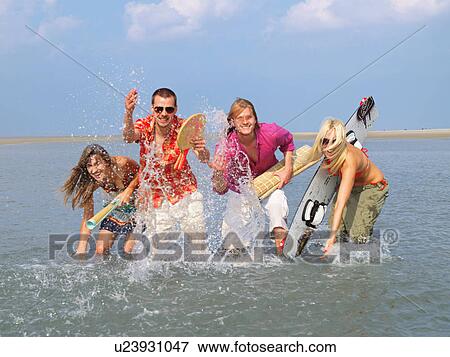 Four young people in the water View Large Photo Image Stock Photo - Four young people in the water. Fotosearch