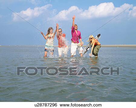 Four young people in the water View Large Photo Image Stock Photograph - Four young people in the water. Fotosearch