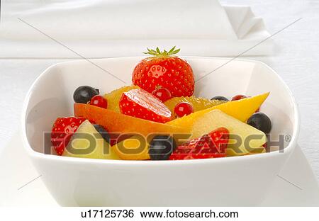 Stock Photograph - Fruit salad in a white porcelain bowl. Fotosearch