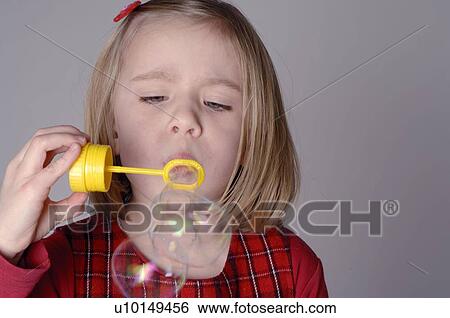 Girl blowing bubbles View Large Photo Image Stock Photograph - Girl blowing bubbles. Fotosearch