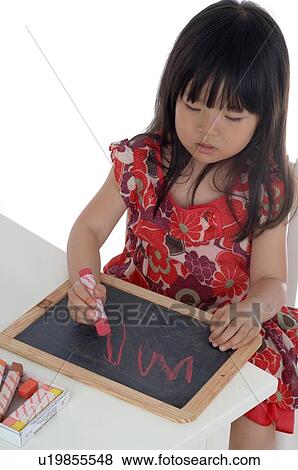 Girl drawing on blackboard View Large Photo Image Stock Photo - Girl drawing on blackboard. Fotosearch