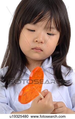 Girl holding lollipop View Large Photo Image Stock Image - Girl holding lollipop. Fotosearch