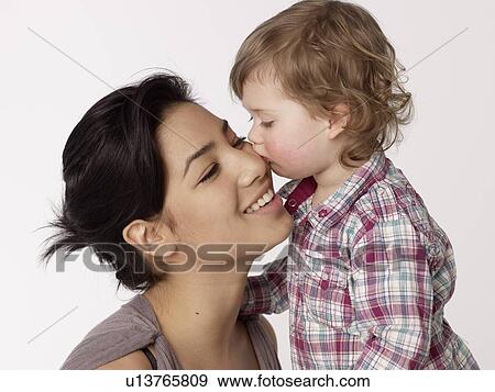Girl kissing woman's cheek View Large Photo Image Stock Photo - Girl kissing woman's cheek. Fotosearch