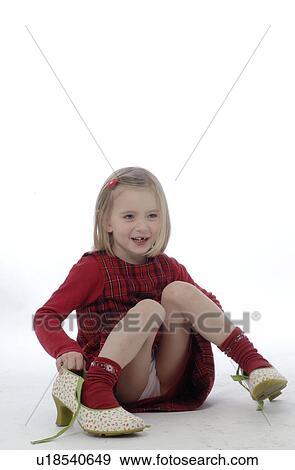 Stock Photo - Girl trying on high heels. Fotosearch