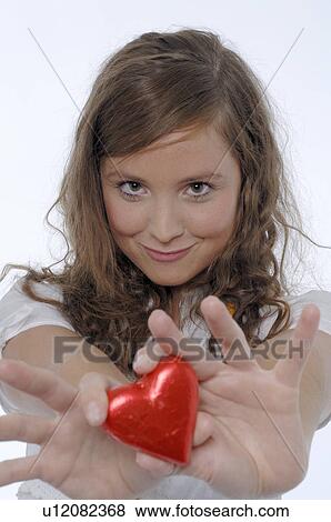 Stock Photo - Girl with chocolate heart. Fotosearch