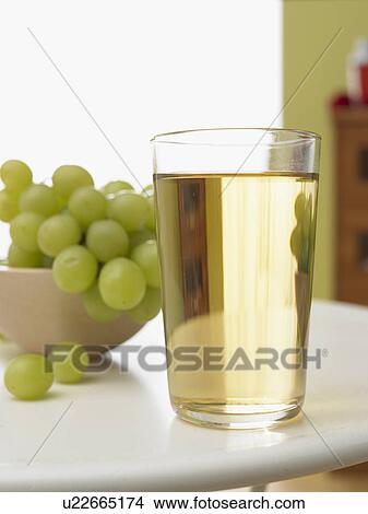 Picture - Glass of white grape juice. Fotosearch