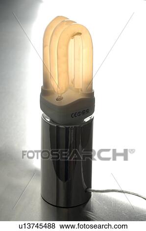 Stock Photo - Illuminated energy saving bulb. Fotosearch