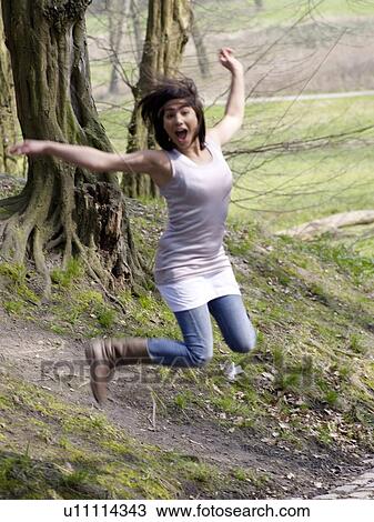 Jolly dark-haired woman in park View Large Photo Image Stock Image - Jolly dark-haired woman in park. Fotosearch