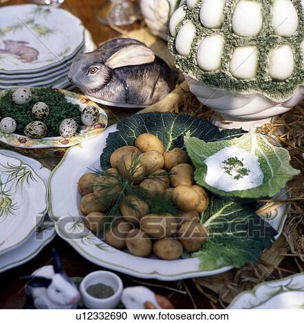 Stock Image - Laid Easter table outdoors. Fotosearch