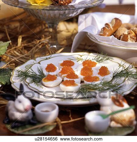 Stock Photograph - Laid Easter table outdoors. Fotosearch