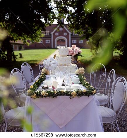 Laid table for wedding celebration in garden View Large Photo Image Stock Photo - Laid table for wedding celebration in garden. Fotosearch