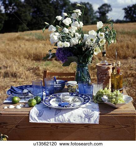 Stock Image - Laid table in a stubble field. Fotosearch