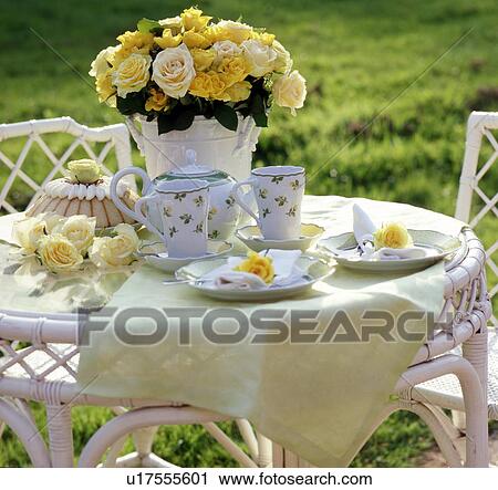 Laid table outdoors with bunch of flowers View Large Photo Image Stock Image - Laid table outdoors with bunch of flowers. Fotosearch