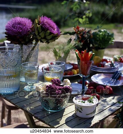 Laid table outdoors with vegetables View Large Photo Image Picture - Laid table outdoors with vegetables. Fotosearch
