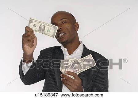 Stock Photo - Looking at banknotes. Fotosearch