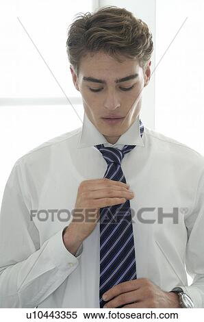 Stock Photography - Man adjusting his tie. Fotosearch