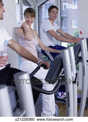 Stock Image - man and woman on training bikes. Fotosearch