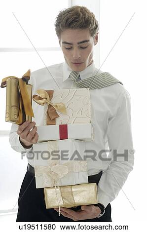 Stock Image - Man carrying presents in his arms. Fotosearch