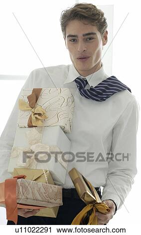 Stock Image - Man carrying presents. Fotosearch