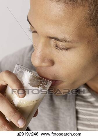 Man drinking latte macchiato View Large Photo Image Stock Photograph - Man drinking latte macchiato. Fotosearch