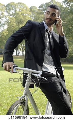 Picture - Man enjoying time-out in the park. Fotosearch