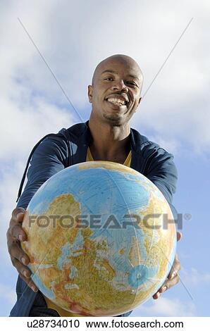 Man holding globe View Large Photo Image Stock Image - Man holding globe. Fotosearch