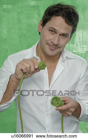 Man holding green plug View Large Photo Image Stock Image - Man holding green plug. Fotosearch