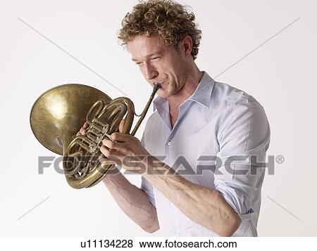 Stock Photo - Man playing horn. Fotosearch