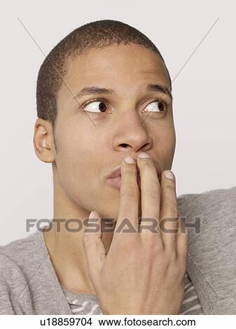 Man putting hand over mouth View Large Photo Image Picture - Man putting hand over mouth. Fotosearch